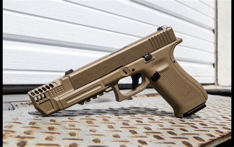 Glock 19x compensator fde - The Glock 19X is Glock’s first “crossover” pistol, combining the large, full-size Glock 17 polymer frame and the smaller Glock 19 all-metal slide. It is the commercial version of the pistol Glock designed for the U.S. Army’s Modular Handgun System competition. The Glock 19X has a number of notable features, including a lanyard loop …